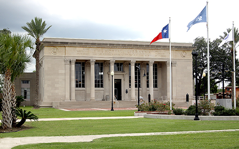 The library building with three flags in front.